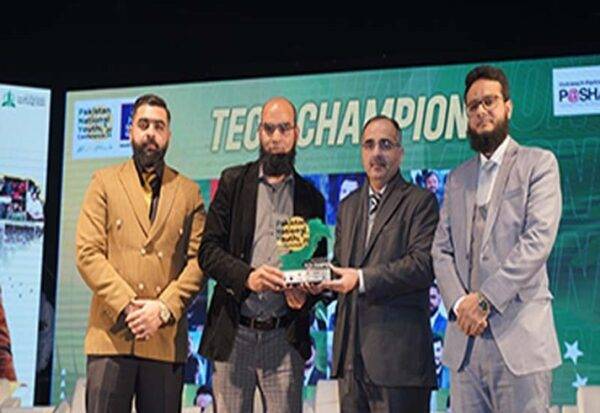 Group of four men at a Tech Champions award ceremony holding a trophy, showcasing recognition in technology innovation.