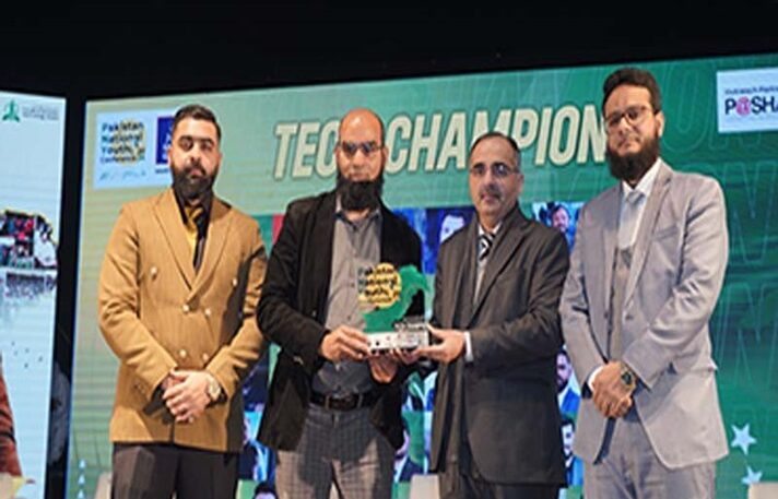 Group of four men at a Tech Champions award ceremony holding a trophy, showcasing recognition in technology innovation.